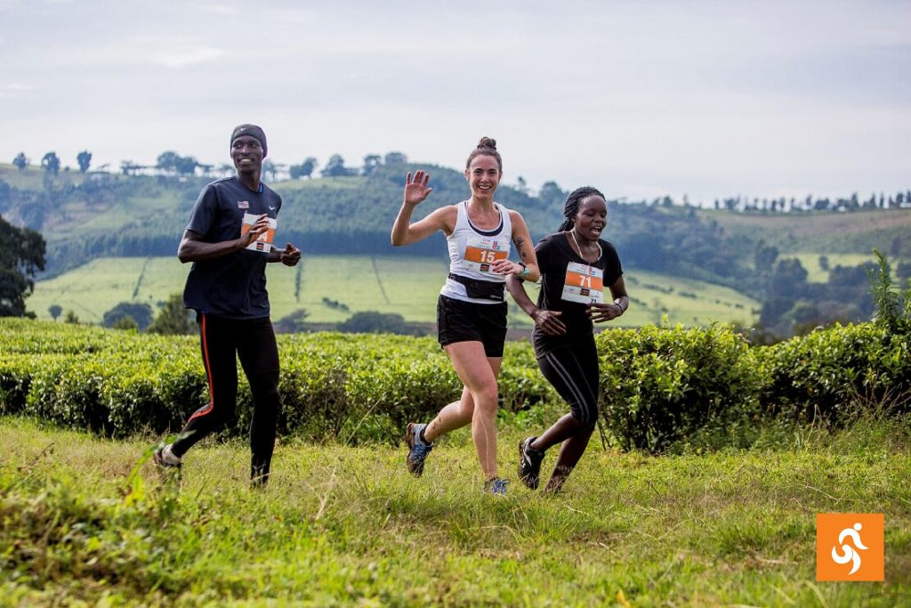 Three Impact Marathon runners in front of a volcano in Guatemala