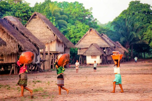 Women carrying baskets in a village near the Cordillera Azul project. Photo © Nancy Stone.