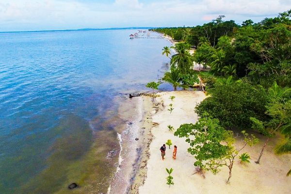 Blue water and beachgoers in the Guatemala Caribbean Coast project.