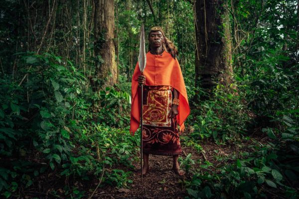 Chief Wilondo Baswa, Customary Chief of the Ntombezale tribe, Lobalu clan, of Mai Ndombe, DRC. The customary Chief is the representative of the ancestors in his community. These clothes reflect ancestral power and are often worn during large traditional ceremonies. The eagle feathers and leopard skin represent ancestral strength, while the red color represents power. Then the ancestral spear or machete represents a warrior. Photo credit: Filip C. Agoo for Wildlife Works Carbon.