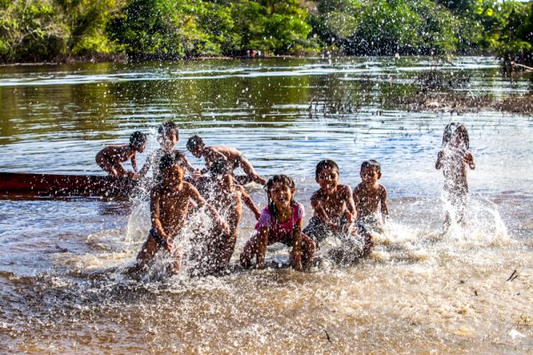 Children splashing in water in the Nii Kaniti project, Peru.