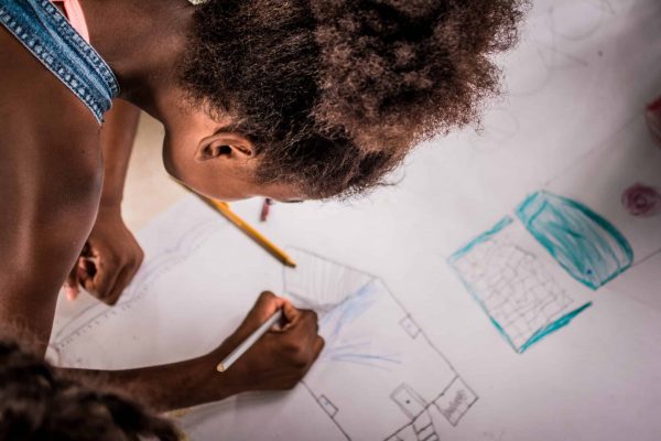 A girl drawing in one of the Pacific Forest Communities projects, Colombia.