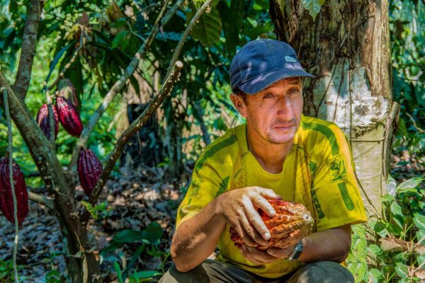 Victor Cordoba, a cacao producer in the Tambopata project, Peru, holds some of his cacao fruits.